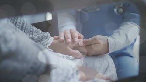 Doctor Comforting Patient While Holding Hands for Encouragement