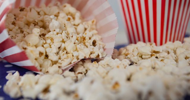 Spilled Popcorn on Table with Striped Box Background - Download Free Stock Images Pikwizard.com