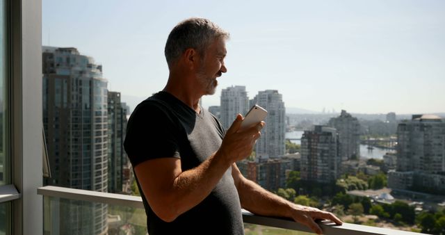 Man With Smartphone Admiring Cityscape From Balcony - Download Free Stock Images Pikwizard.com