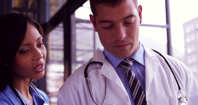 Two healthcare professionals are intently discussing patient care details. - Download Free Stock Photos Pikwizard.com