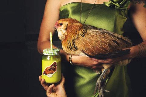 Woman holding chicken with chicken-inspired photo