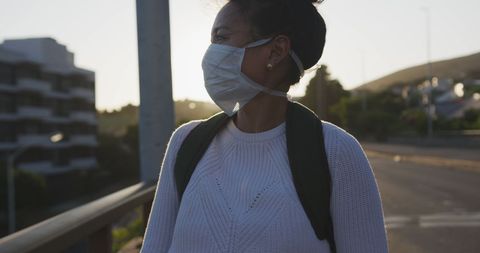 Young Woman in Mask Exploring City Streets During Pandemic