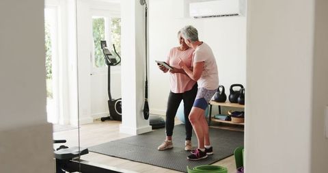 Senior Same-Sex Couple Enjoying Home Fitness Experience