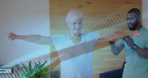 Senior Woman Completing Dumbbell Workout with Personal Trainer