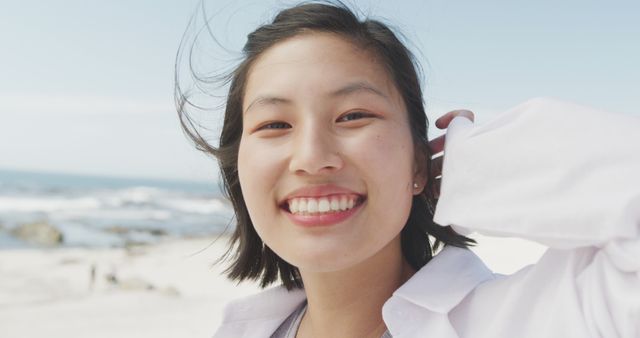 Smiling Young Woman Enjoying a Day at the Beach - Download Free Stock Images Pikwizard.com