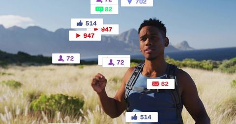 Hiking man receiving floating social media notifications on coastal trail