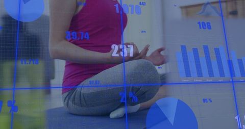 Woman meditating at home with digital charts overlay connecting mindfulness and data