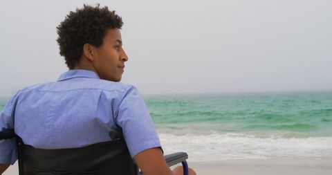 Person in Wheelchair Reflecting at Ocean, Calm Beach Moment