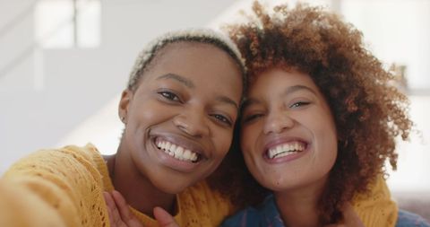 Joyful Lesbian Couple Embracing at Home