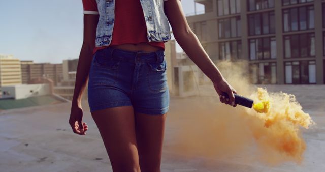 Young Woman Holding Smoke Bomb on Rooftop in Urban Area - Download Free Stock Images Pikwizard.com