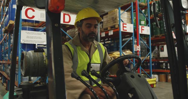 Warehouse Worker Operating Forklift in Industrial Storage Facility - Download Free Stock Images Pikwizard.com