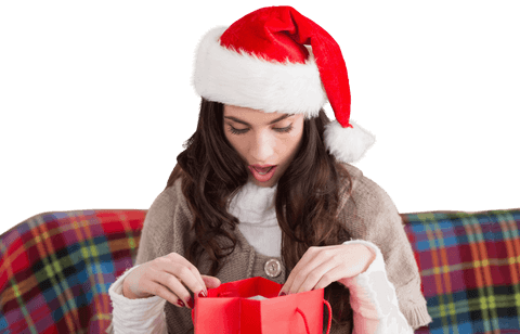 Excited Woman in Santa Hat with Gift on Transparent Background