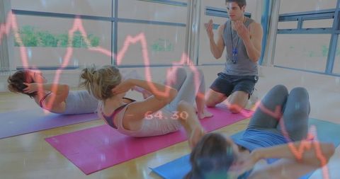 Group Fitness Class Performing Crunches with Trainer Coaching and Heart Rate Overlay