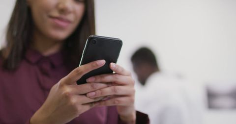 Businesswoman Engaging with Smartphone in Modern Office Environment - Download Free Stock Images Pikwizard.com
