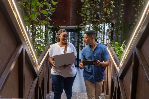 Diverse Professionals Collaborating in Modern Green Workspace