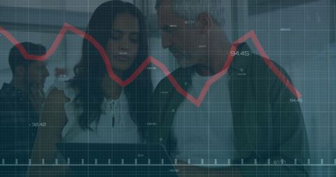 Business Analysis Team Examining Financial Data Trends in Modern Office