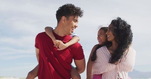 Smiling Family Enjoying Beach Day Together