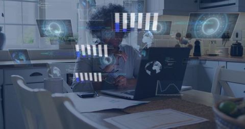 Senior african american woman working remotely at kitchen table with data hud interface