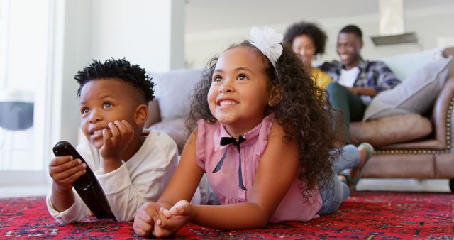 Happy Children Watching Television while Parents Relax in Background - Download Free Stock Images Pikwizard.com