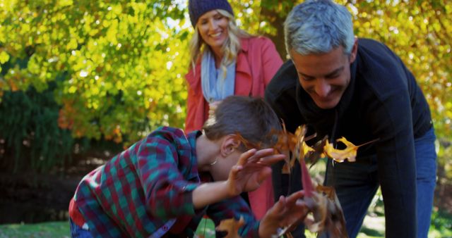 Family Enjoying Autumn Day in Park with Fall Leaves - Download Free Stock Images Pikwizard.com