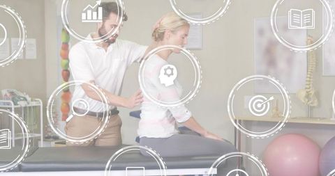 Physiotherapist performing manual spinal therapy on patient in clinic rehabilitation session