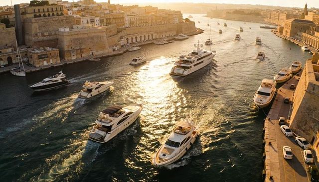 Luxury yachts cruising through historic limestone harbor at golden hour