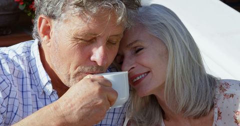 Senior Couple Enjoying Coffee Highlighting Bond and Comfort