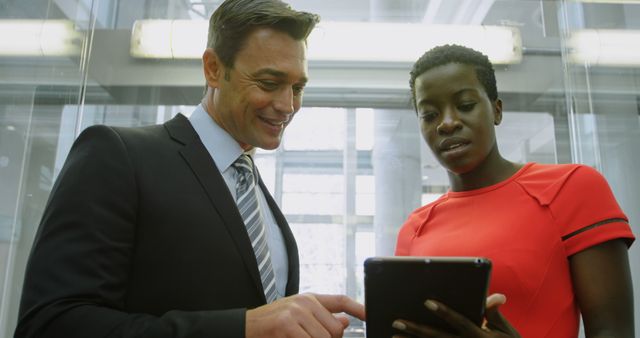 Businessman and Businesswoman Discussing Work on Tablet - Download Free Stock Images Pikwizard.com