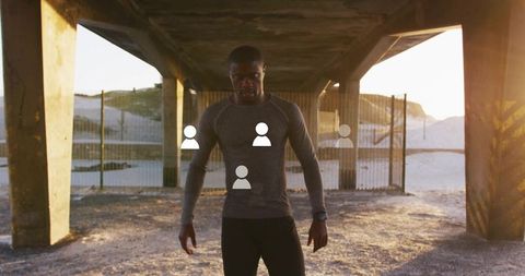 Athletic man exercising at sunset near coastal concrete structure