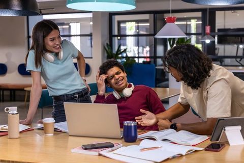 Multicultural Students Collaborating and Discussing in Group Study at Modern Coworking Space