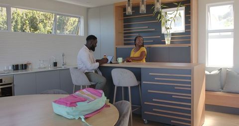 African American Couple Enjoying Breakfast in Modern Kitchen