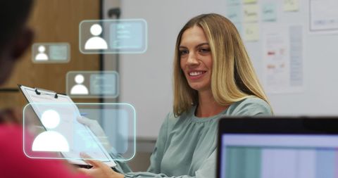 Businesswoman reviewing digital profiles in modern office