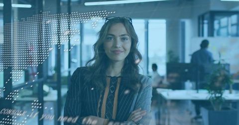Confident female leader standing behind glass partition in modern office with digital map overlay