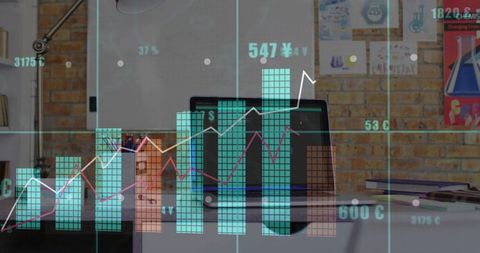 Workspace showing laptop with teal bar charts and magenta line graphs projecting analytics