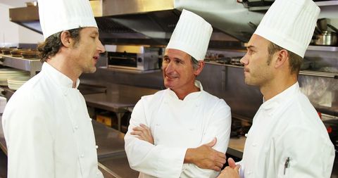 Chefs Discussing in Professional Kitchen Environment