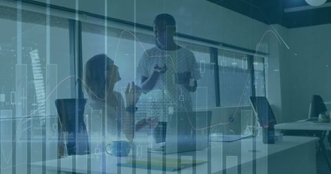 Coworkers Discussing Financial Data in Modern Office