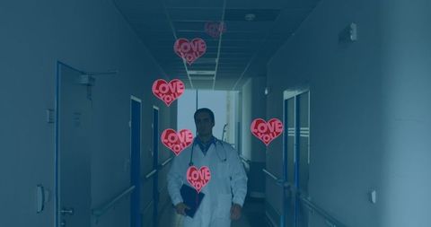 Doctor walking corridor with love heart messages in hospital
