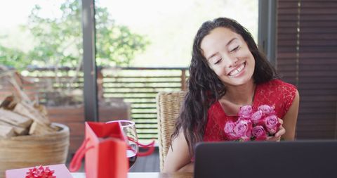 Biracial Woman Enjoying Virtual Valentine Celebration with Roses - Download Free Stock Images Pikwizard.com