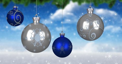 Festive Christmas Ornaments Hanging in Snowy Winter Scene