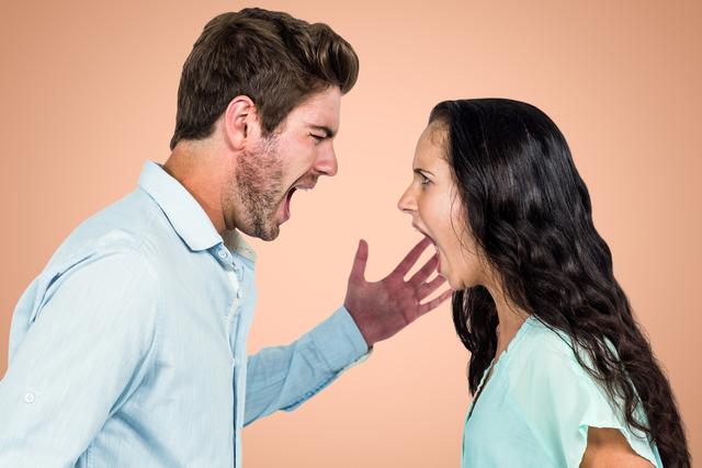 The image depicts an angry couple shouting at each other against an orange background. It is ideal for illustrating concepts related to relationship problems, emotional stress, conflict resolution, and communication issues. Can be used in articles, blogs, social media posts, or advertising content dealing with couples therapy, mental health, or relationship advice.