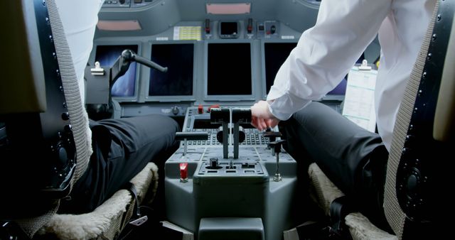 Pilots are sitting in a cockpit, operating aircraft controls. One of them is adjusting the throttle while the other is monitoring the instruments. Designed for use in aviation-related content, career training materials, and articles about air travel safety, technology, and professional expertise in aviation.