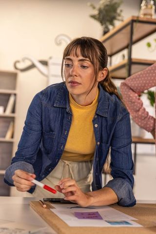 Focused Woman Collaborating in Modern Workspace on Creative Project