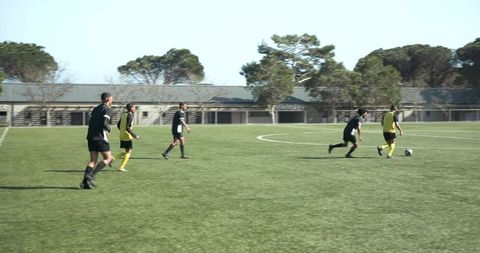 Soccer Players Practicing on Sunny Day in Team Jerseys