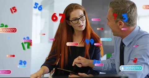 Business team discussing augmented reality data overlays on tablet in modern office