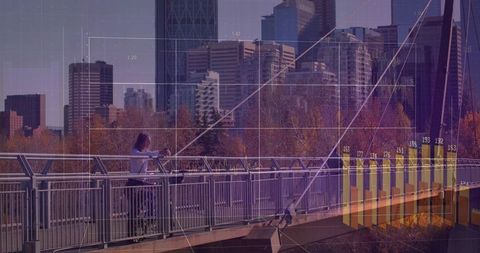 Leaning man using smartphone on river bridge with financial data overlay city skyline
