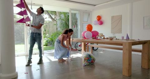 Couple preparing living room for celebratory gathering