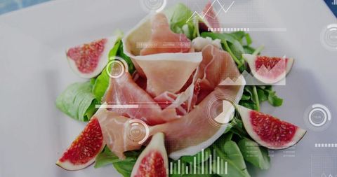 Prosciutto rosette on arugula with fresh fig wedges and futuristic hud data overlay