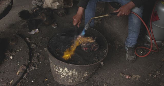 Man Flamethrowing Goat Head for Cooking Preparation Outdoors Rustic Setting - Download Free Stock Images Pikwizard.com