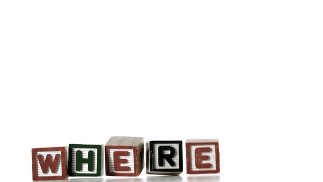 Colorful alphabet blocks spelling the word 'WHERE' dropping in slow motion against a white background, suitable for educational materials, children's learning resources, and playful marketing content