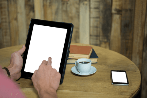 transparent tablet screen with coffee and smartphone on wooden table - Download Free Stock Videos Pikwizard.com